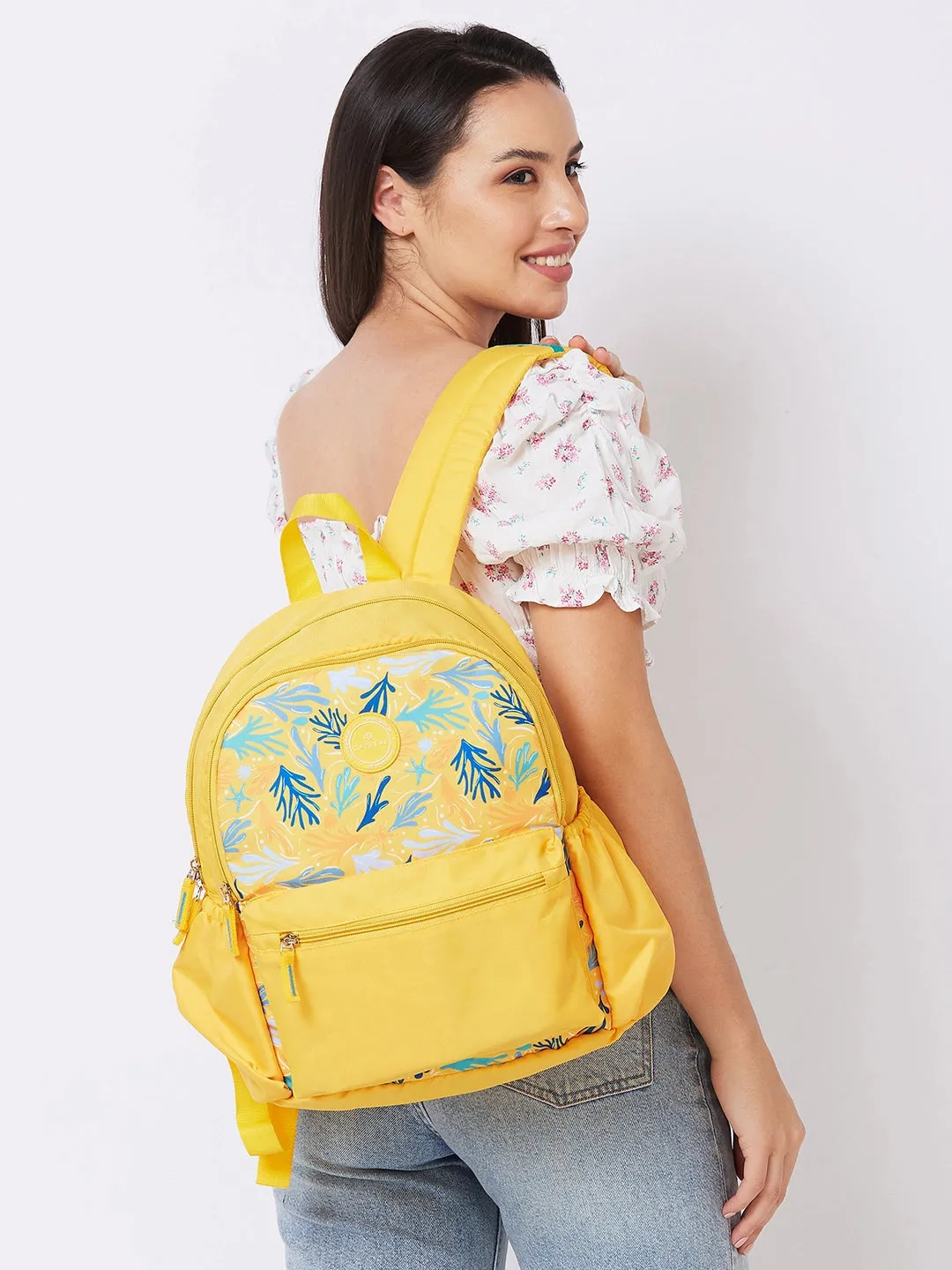 Caprese Xenia Backpack Medium Dual Compartment Yellow Printed