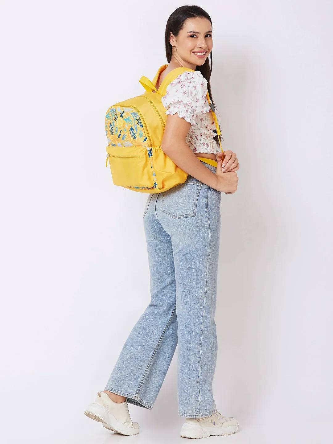 Caprese Xenia Backpack Medium Dual Compartment Yellow Printed